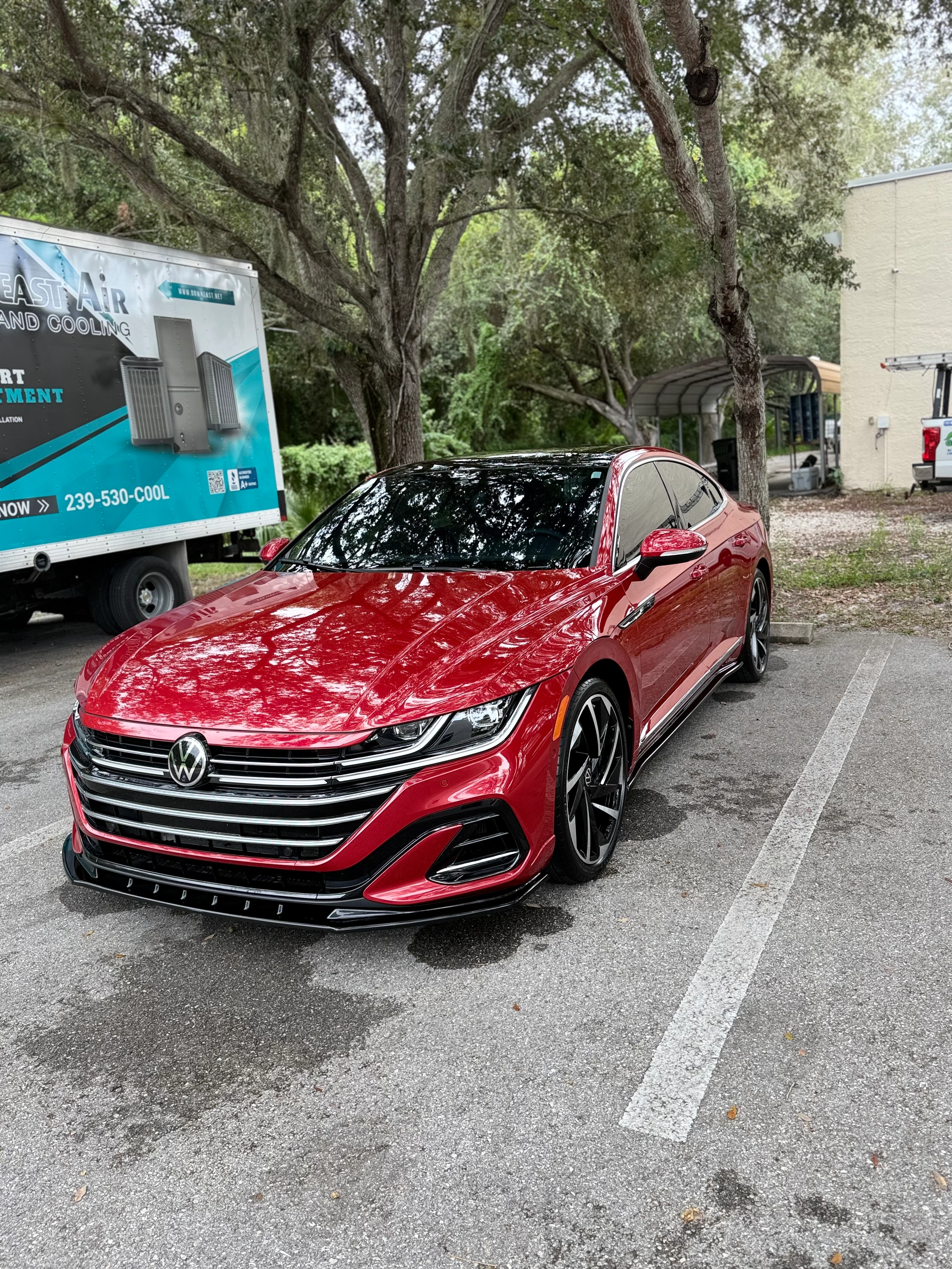 Freshly detailed red sedan with glossy paint finish